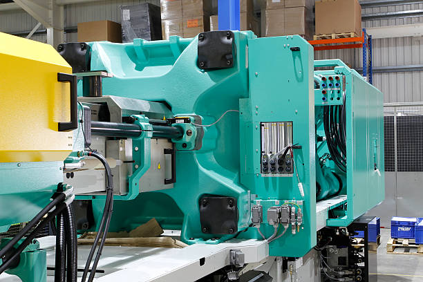 Injection moulding machine Injection moulding machine used for the forming of plastic parts using plastic resin and polymers. injecting stock pictures, royalty-free photos & images