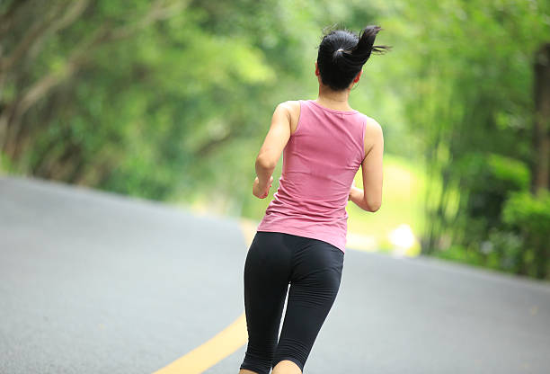 istock young asian woman running in forest 179078208