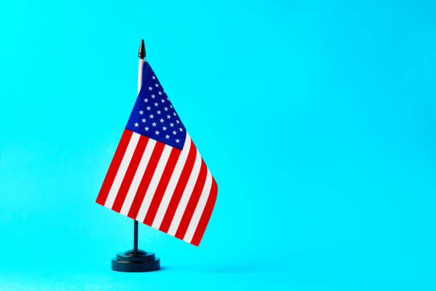 istock Small flag of USA on flagpole on studio background 1790782893