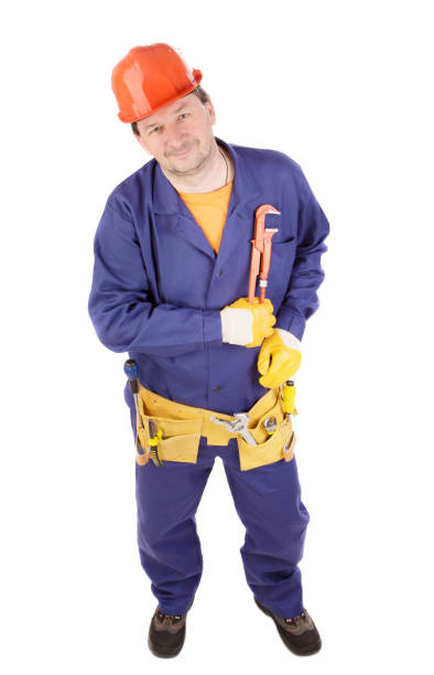 istock Worker in protective helmet holds an adjustable wrench in his hand. 1790783625