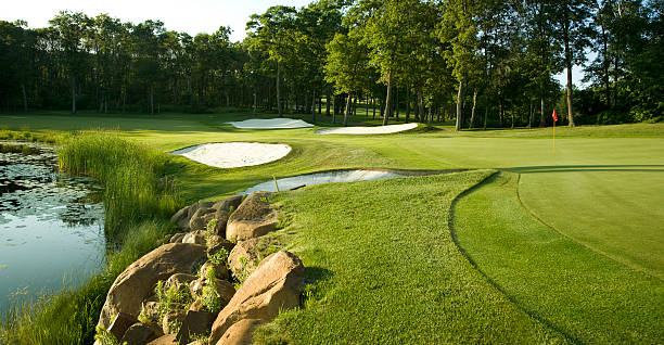 istock Golf green with traps and water XL 179078493