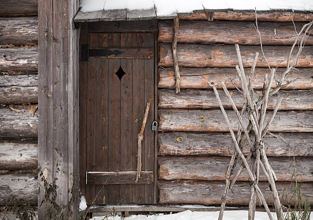 Old weathered barricaded barn entrance gate