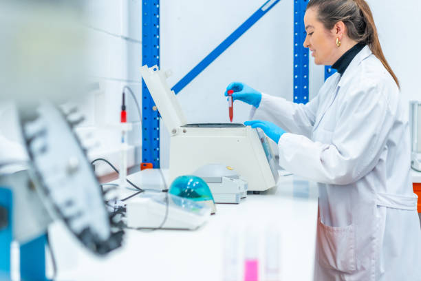 istock Scientist placing a blood sample in a centrifuge in a research laboratory 1790787520
