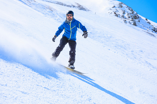 Snowboarding   Man snowboarding  on the mountain ski resort, perfect ski slope.