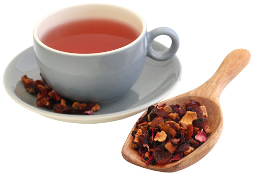 Herbal tea of roselle, rose hips and apple closeup and isolated