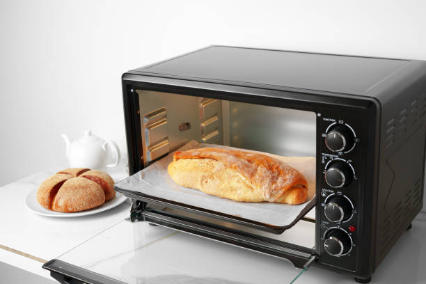 istock Freshly baked bread in mini oven in the kitchen 1790801636