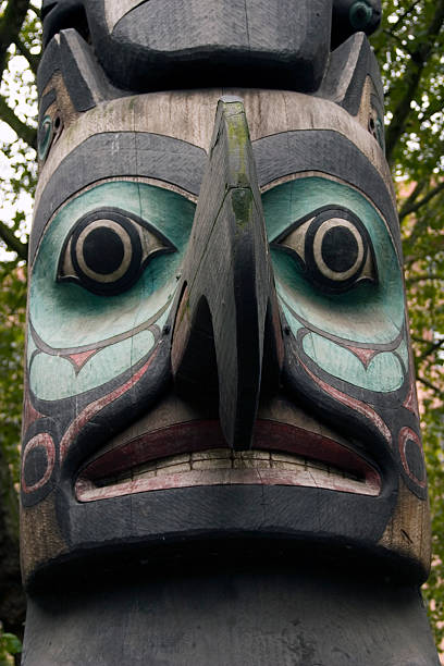 Totem Pole Face "Vertical photo of a totem pole in Seattle, Washington" pacific northwest totem poles stock pictures, royalty-free photos & images