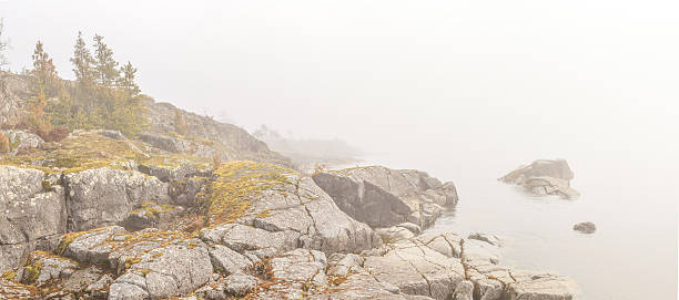 istock Fog on stony coast of lake.  spring landscape 179081010