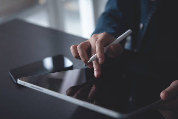istock Close up of woman hand using digital tablet, finger touching on screen, reading E-book via E-reader mobile app at office, digital education, online working, freelance at work 1790814138