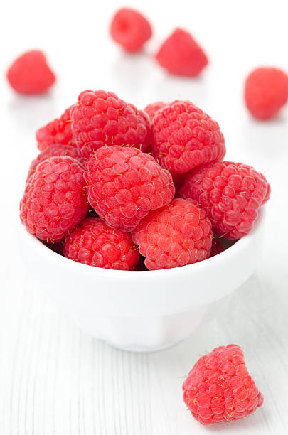istock fresh raspberries in a bowl, vertical close-up 179081432