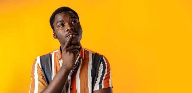 istock Young african man thinking against yellow background 1790815052