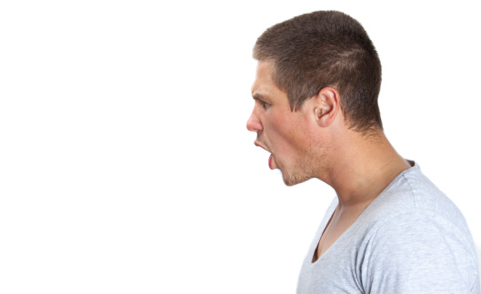 Young man shouting in profile on white isolated background