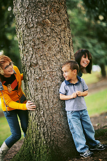 istock Three Cousins Playing Hide and Go Seek in a Park 179082033
