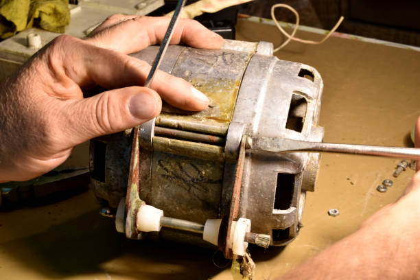 istock An electrician repairs an engine with a screwdriver and a wrench. 1790826106