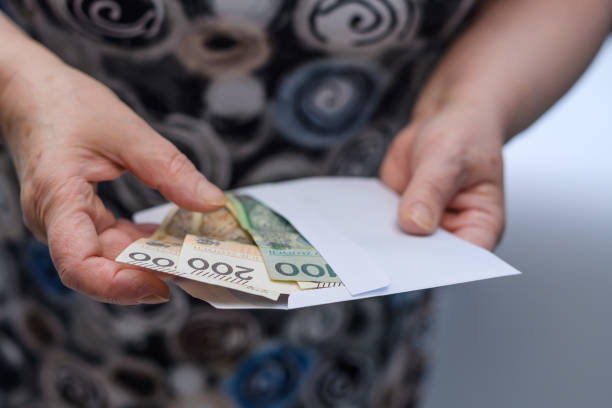 istock An old lady holds a pension in an envelope 1790830364