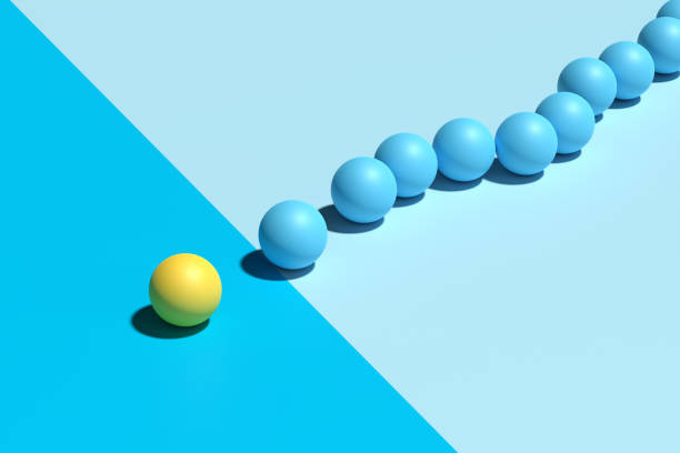 Yellow sphere sits apart from a group of blue spheres. Exclusion, separation, division, boundaries and barrier concepts. 3d render.