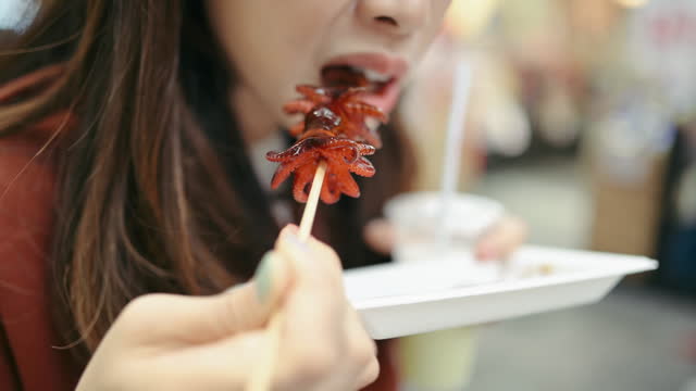 Asian solo travel try Baby marinated octopus at the Tsukiji market in Kyoto japan