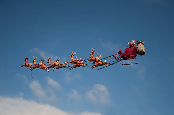 Santa's Sleigh Santa's Sleigh flying above the city during Christmas animal sleigh photos stock pictures, royalty-free photos & images