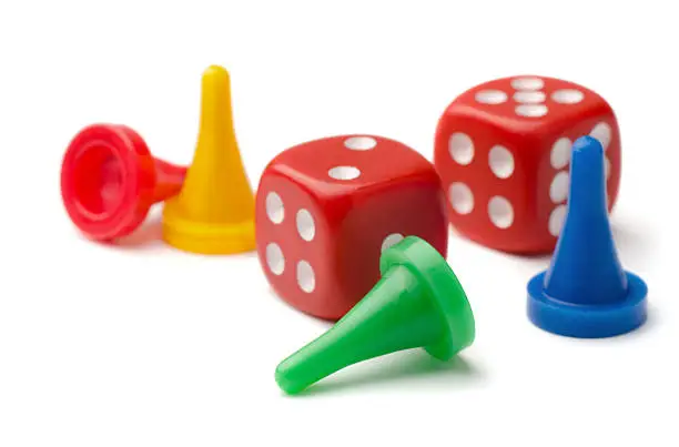 Photo of Game pieces and two dice on white background