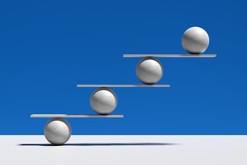 Harmony, balance, equilibrium and stability concepts. Spheres balancing on a seesaw. Abstract 3D render.