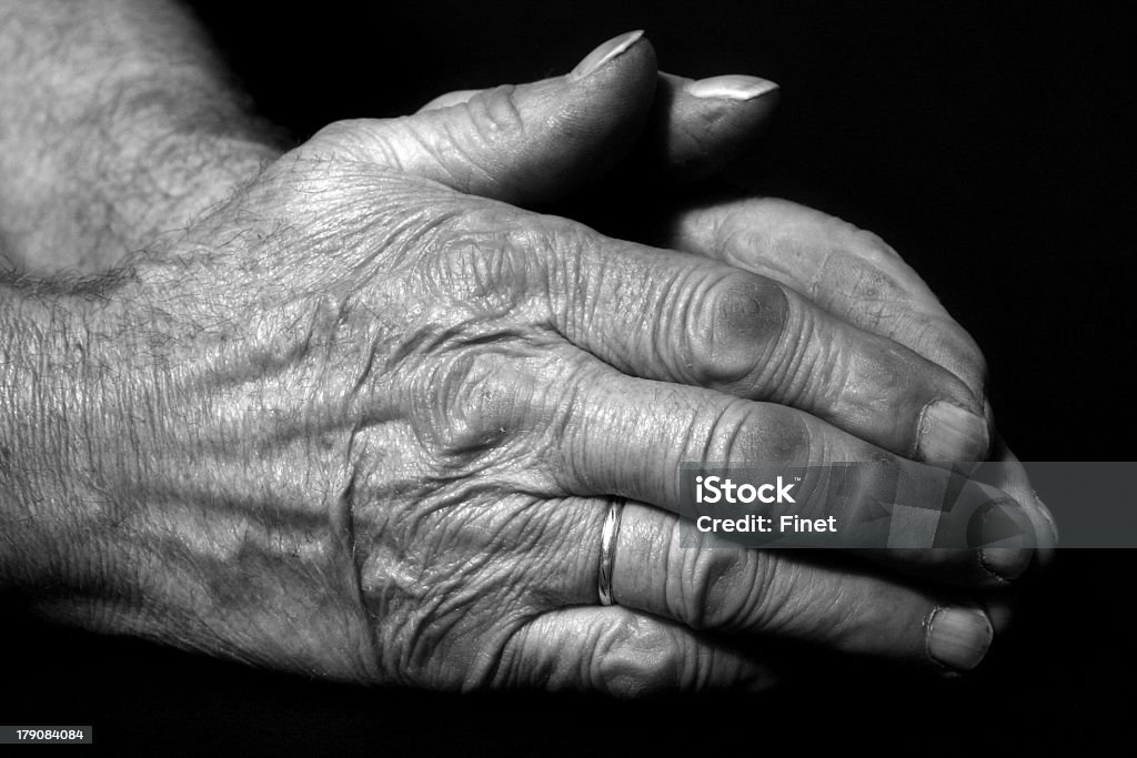 Praying hands - betende Hände Verry old male praying hands on black background. Close-up Stock Photo