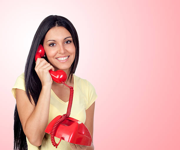 istock Attractive brunette girl calling with red phone 179084309