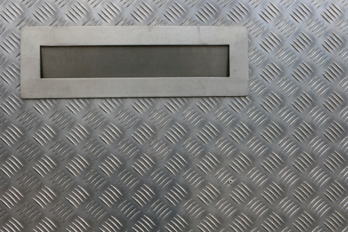 Metal letter box on a steel door
