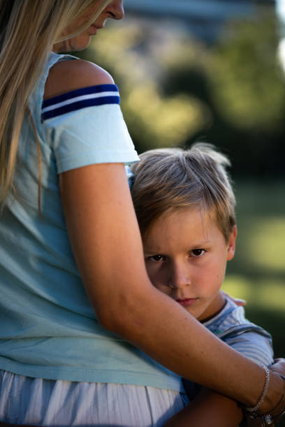 istock A sad boy in his mother's arms 1790845976