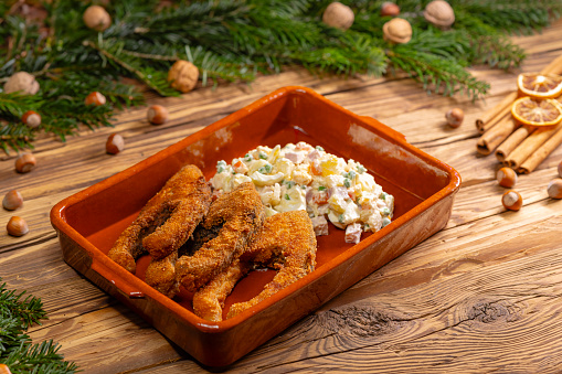 Traditional Christmas dinner in Czech Republic - fried carp with potato salad