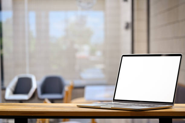 istock Laptop computer on wooden table with blurred coy office interior on background 1790851567