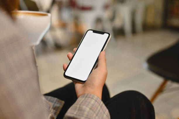 istock Woman in stylish suit drinking coffee and using mobile phone at cafe. Empty screen for your advertising text message 1790852625