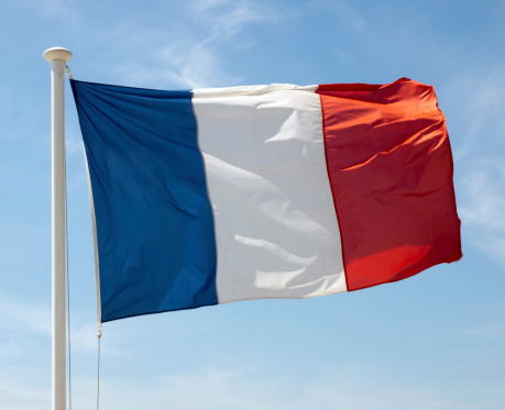 Flag of France waving against blue sky