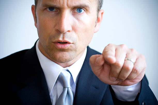 istock A man in a suit with piercing blue eyes pointing his finger 179085679