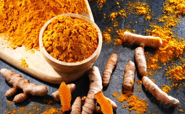 istock Composition with a bowl of ground turmeric and its fresh rhizome 1790859575