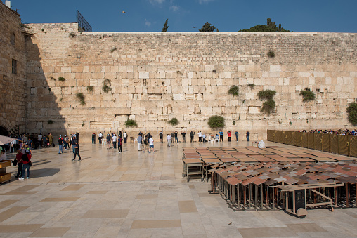 Jerusalem, Israel - May 15, 2018: Jews and tourists praying at the Western Wall, called also as the Wailing Wall, the holiest place for Judaism