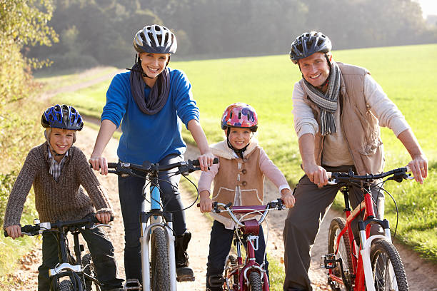 istock Young family pose with bikes in park 179087401
