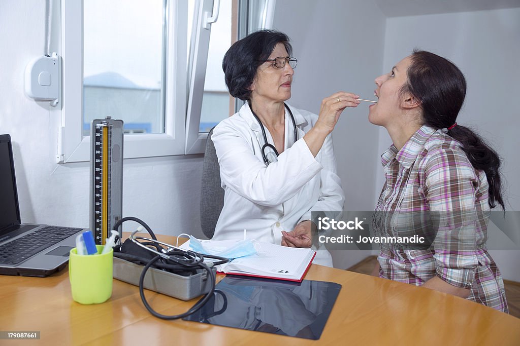 Female doctor examining her patient Thyroid Exam Stock Photo