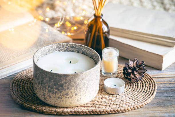 istock Cozy winter composition with candles on a blurred background with books. 1790878248