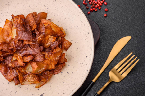 istock Delicious crispy potato chips with salt and spices 1790892411
