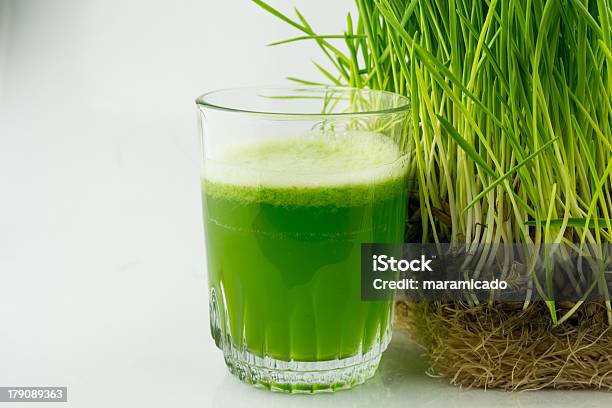 Green Organic Wheat Grass Juice Beside A Wheat Grass Plant Stock Photo - Download Image Now