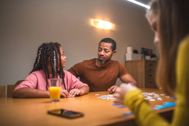 istock Mixed Race Parents and Daughters with Puzzles 1790901265