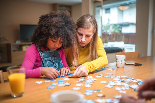 istock Mother and Mixed Race Daughter Enjoying Puzzles 1790901272