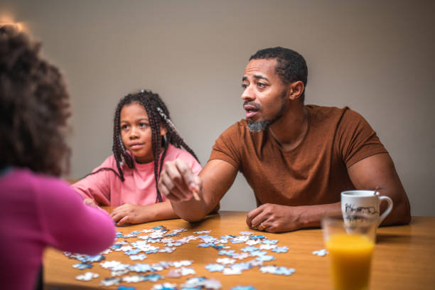 istock Black Father and Daughters Enjoying Puzzles 1790901278