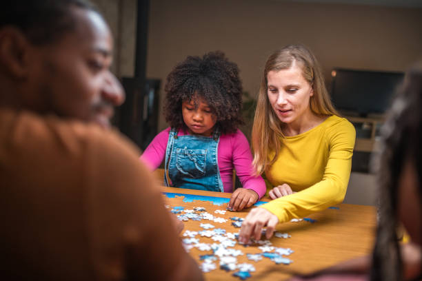 istock Mixed Race Parents and Daughters with Puzzles 1790901290