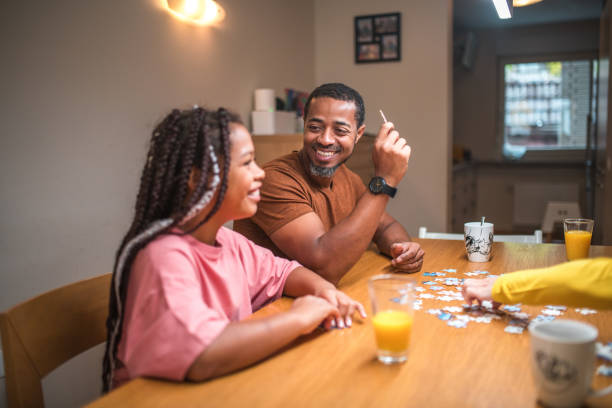 istock Black Father and Mixed Race Daughter Enjoying Puzzles 1790901299