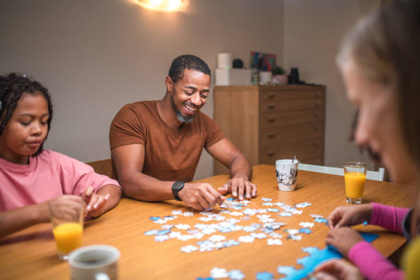 istock Mixed Race Parents and Daughters with Puzzles 1790901305