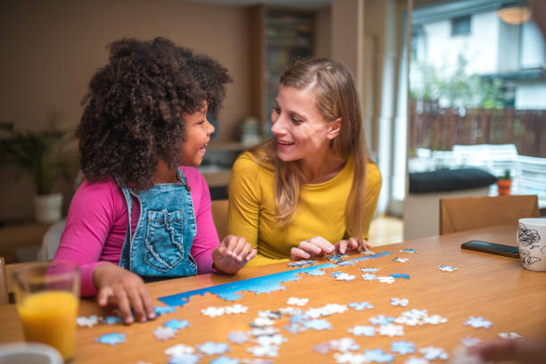 istock Mother and Mixed Race Daughter Enjoying Puzzles 1790901308