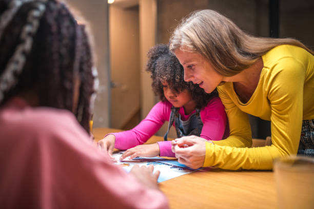 istock Mother and Two Daughters Enjoying Puzzles 1790901334