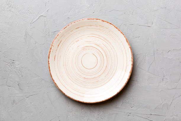 Top view of empty colorful plate on cement background. Empty space for your design