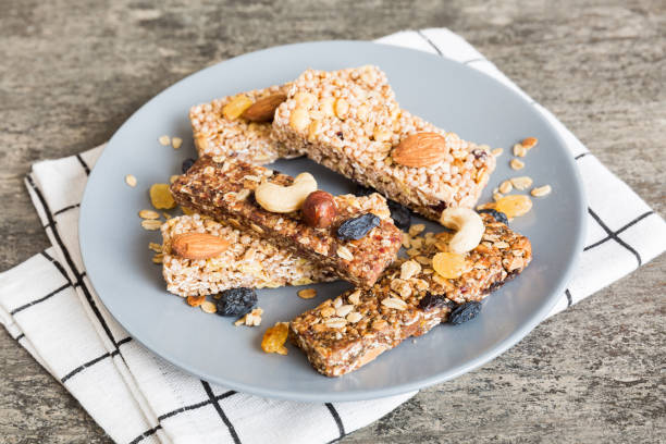 istock Various granola bars on table background. Cereal granola bars. Superfood breakfast bars with oats, nuts and berries, close up. Superfood concept 1790906414